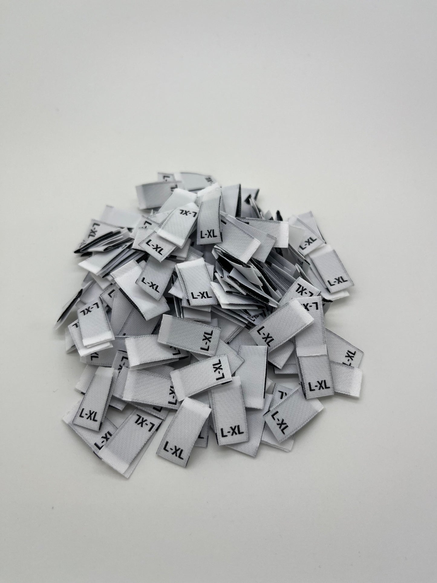 White size label with Black text ( XS/S, S/M, M/L, & L/XL)